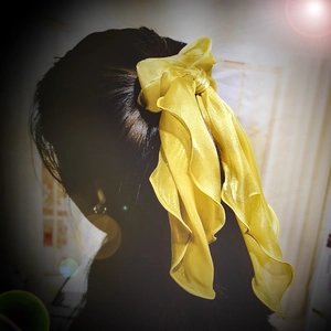 Elegant yellow satin ribbon hair scrunchie with large bow and long streamers on model