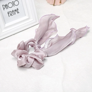 Detailed view of lavender satin scrunchie with long ribbons and premium sewing edge