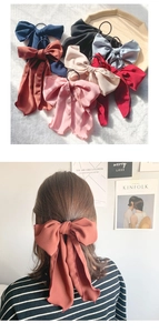 Detail of elegant large ribbon bow hair ties in seven assorted matte colors for women