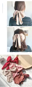 Close-up of elegant oversized chiffon bow hair ties in red, pink, beige and caramel