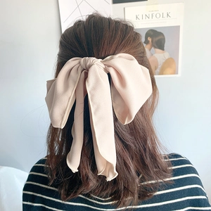 Elegant beige chiffon bow hair tie with long ribbons on back-view model