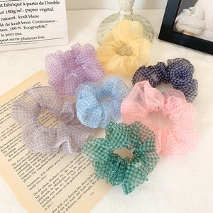 Set of 7 colorful checkered organza scrunchies in pastel tones on white fabric