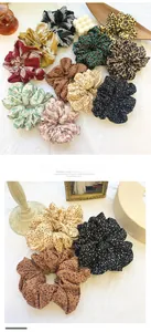 Close-up of oversized floral and leopard print scrunchies in chiffon fabric