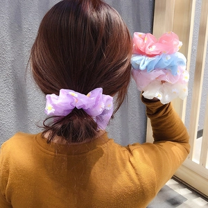 Detail of sheer organza daisy hair scrunchies showing purple version worn on hair