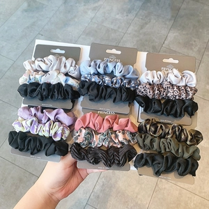Detailed view of three-piece silk satin scrunchie sets in floral and leopard prints