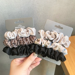 Three-piece set of elegant silk satin scrunchies in beige, black, and leopard print colors