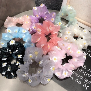 Detailed set of colorful daisy print chiffon scrunchies in pastel and neutral tones