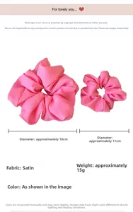 Detail view of large and small pink satin scrunchies with 18cm and 11cm diameter