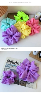 Detail view of colorful oversized chiffon organza scrunchies in various candy colors
