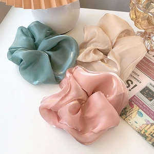 Oversized organza scrunchies in mint green, champagne gold, and soft pink colors