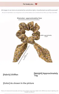 Detail eines gelben Blumen-Haargummis aus Chiffon mit Maßen 9cm Breite und 10cm Band