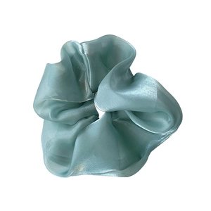 Oversized light blue organza hair scrunchie with pearlescent finish and ruffled design