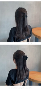 Detail of matte black floral hair claw clip used for elegant updo hairstyle styling