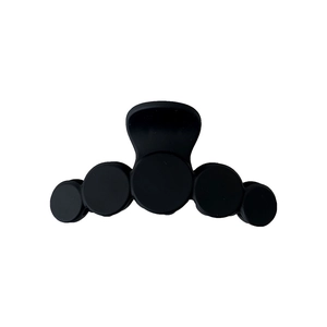 Minimalist black matte bow hair claw clip with five circular design elements for women