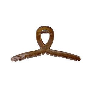 Minimalist amber brown large twist hair claw clip with crossed design for women's hairstyle