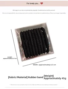 Detail view of black high-elastic hair ties in a 6.5cm square storage box pack