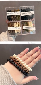 Detail of earthy-tone spiral phone cord hair ties in a transparent 6-pack box gift set