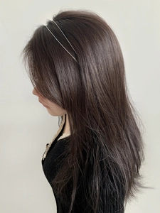 Detail view of double-layered slim silver metal headband on model with gray background