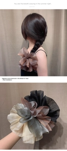 Détail de chouchous géants en organza multicolores portés sur les cheveux et en main