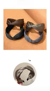 Detailed view of wide pleated headbands in silk fabric showing twist design and anti-slip edge