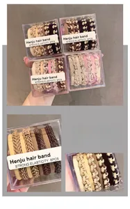 Close-up of 8-piece woven elastic hair bands in assorted earth tones and acrylic box