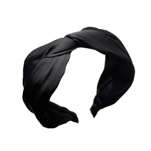 Black pleated satin headband with a twisted knot design for a high top hair styling