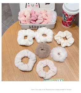 Gros plan de chouchous assortis en peluche et velours côtelé aux tons rose, beige et brun