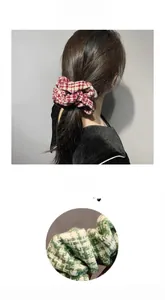 Detail view of houndstooth knit scrunchies in red and green soft fabric