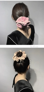 Detail showing oversized houndstooth tweed scrunchies in pink and brown on hair