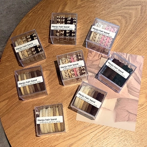 Set of 8 heavy-duty elastic woven hair ties in earth-tone colors with acrylic box