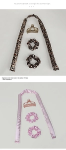 Detail view of leopard print and pink silk heatless hair curling sets with clips
