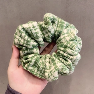 Retro oversized green and white houndstooth knit scrunchie with soft fabric texture
