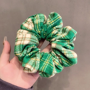 Classic green plaid fabric scrunchie with soft cotton texture and oversized puffy design