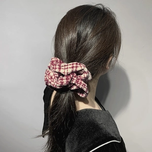Retro red and white houndstooth knit scrunchie with soft pleated fabric texture