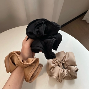 Three oversized satin scrunchies in black, brown and champagne gold colors