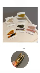 Detail view of acetate hair clip set with metallic duckbill clips and colorful textures