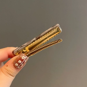 Brown marble acetate hair clip with golden metal base for women side hair styling