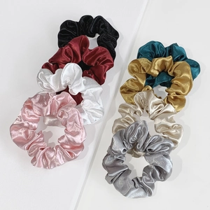 Eight-piece set of colorful satin scrunchies in metallic silk finish on white background