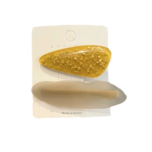 Fashionable acetate hair clip set in ginger yellow and marble grey on branded card