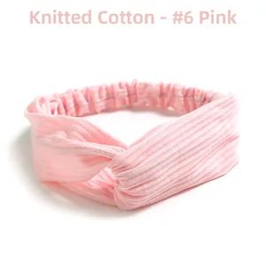 Detail view of pink knitted cotton headband with twist knot design and elastic band