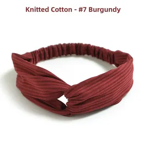 Detail of burgundy knitted cotton headband showing twisted design and ribbed texture