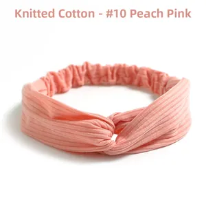 Detail showing the peach pink ribbed knit cotton headband with a stylish twist knot