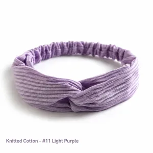 Detail of light purple knitted cotton twist knot headband with ribbed texture and elastic band
