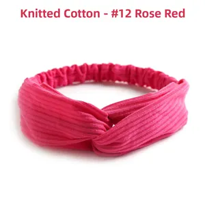 Detail of rose red knitted cotton headband showing ribbed texture and elastic band
