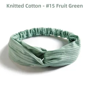 Close-up of fruit green knit cotton headband with ribbed texture and twisted design