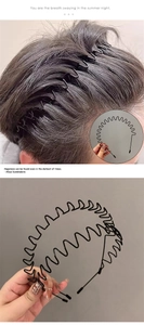 Detail of black wavy metal headband for men showing comb teeth design and styling effect