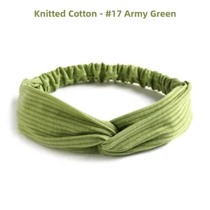Detail of army green knitted cotton headband showing twisted knot and elastic texture