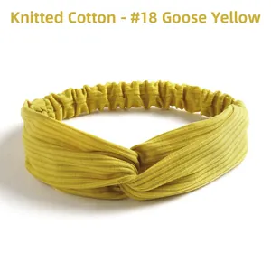 Detail of goose yellow knitted cotton headband with elastic twist and ribbed texture