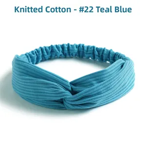 Detailed texture of peacock blue knitted cotton cross twist headband with ribbed pattern