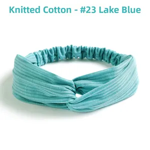 Detail of lake blue elastic cross knot headband made of soft ribbed knit cotton fabric